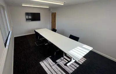 Meeting table with wall-mounted screen